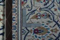 Backside of handmade 2000s Kashan rug showing knot structure and weave density