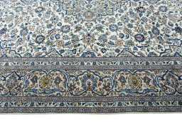 Corner detail of 2000s Kashan rug showing border pattern and Wool pile