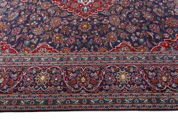 Corner detail of 2000s Kashan rug showing border pattern and Wool pile