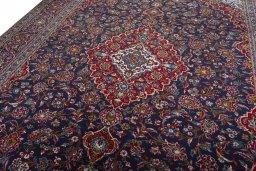 Backside of handmade 2000s Kashan rug showing knot structure and weave density