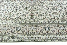 Corner detail of 2000s Kashan rug showing border pattern and Wool pile