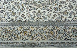 Corner detail of 2000s Kashan rug showing border pattern and Wool pile