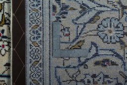 Backside of handmade 2000s Kashan rug showing knot structure and weave density