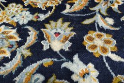 Backside of handmade 1970s Kashan rug showing knot structure and weave density