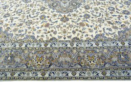 Corner detail of 2000s Kashan rug showing border pattern and Wool pile