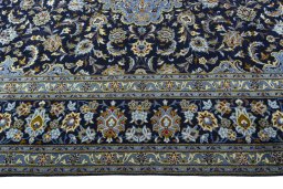 Corner detail of 2000s Kashan rug showing border pattern and Wool pile