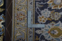 Backside of handmade 2000s Kashan rug showing knot structure and weave density