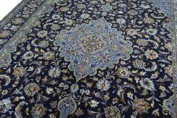 Backside of handmade 2000s Kashan rug showing knot structure and weave density
