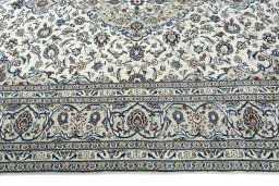 Corner detail of 2000s Kashan rug showing border pattern and Wool pile