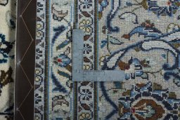 Backside of handmade 2000s Kashan rug showing knot structure and weave density