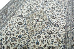 Backside of handmade 2000s Kashan rug showing knot structure and weave density