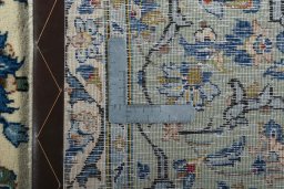 Backside of handmade 2000s Kashan rug showing knot structure and weave density