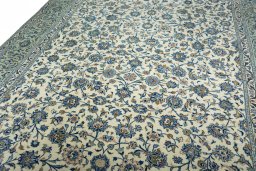 Backside of handmade 2000s Kashan rug showing knot structure and weave density