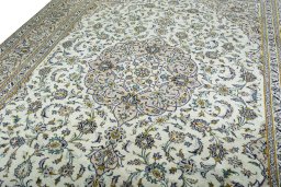 Backside of handmade 2000s Kashan rug showing knot structure and weave density