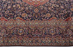 Corner detail of 2000s Kashan rug showing border pattern and Wool pile