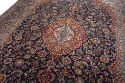 Backside of handmade 2000s Kashan rug showing knot structure and weave density