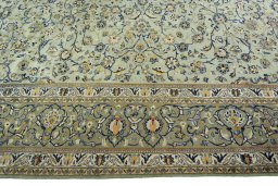 Corner detail of 2000s Kashan rug showing border pattern and Wool pile