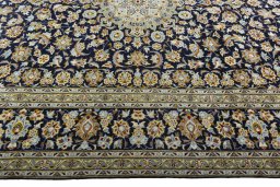 Corner detail of 2000s Kashan rug showing border pattern and Wool pile