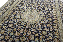 Backside of handmade 2000s Kashan rug showing knot structure and weave density