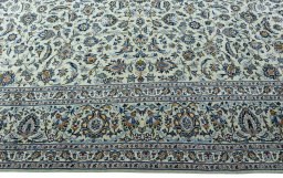 Corner detail of 2000s Kashan rug showing border pattern and Wool pile