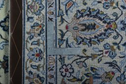 Backside of handmade 2000s Kashan rug showing knot structure and weave density