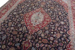 Backside of handmade 2000s Kashan rug showing knot structure and weave density