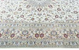 Corner detail of 2000s Kashan rug showing border pattern and Wool pile