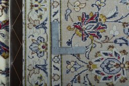 Backside of handmade 2000s Kashan rug showing knot structure and weave density