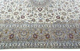 Corner detail of 2000s Kashan rug showing border pattern and Wool pile