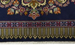 Backside of handmade New Kashan rug showing knot structure and weave density