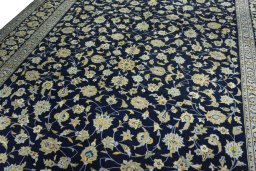Backside of handmade 1970s Kashan rug showing knot structure and weave density
