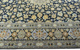 Corner detail of 2000s Kashan rug showing border pattern and Wool pile