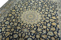 Backside of handmade 2000s Kashan rug showing knot structure and weave density