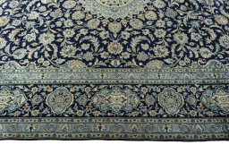 Corner detail of 2000s Kashan rug showing border pattern and Wool pile