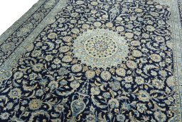 Backside of handmade 2000s Kashan rug showing knot structure and weave density