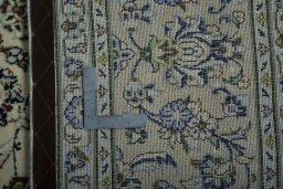 Backside of handmade 2000s Kashan rug showing knot structure and weave density