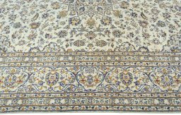 Corner detail of 2000s Kashan rug showing border pattern and Wool pile