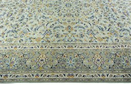 Corner detail of 2000s Kashan rug showing border pattern and Wool pile