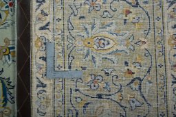 Backside of handmade 2000s Kashan rug showing knot structure and weave density