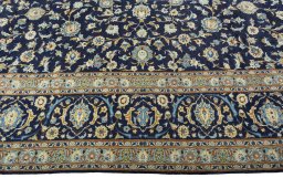 Corner detail of 2000s Kashan rug showing border pattern and Wool pile