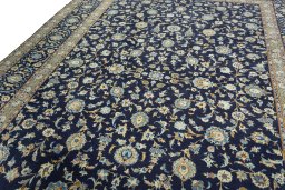 Backside of handmade 2000s Kashan rug showing knot structure and weave density