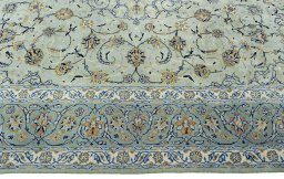 Corner detail of 2000s Kashan rug showing border pattern and Wool pile