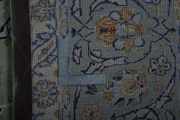 Backside of handmade 2000s Kashan rug showing knot structure and weave density