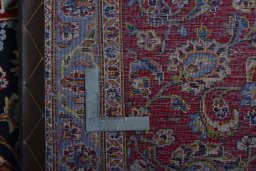 Backside of handmade 2000s Kashan rug showing knot structure and weave density