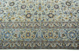 Corner detail of 2000s Kashan rug showing border pattern and Wool pile