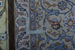 Backside of handmade 2000s Kashan rug showing knot structure and weave density