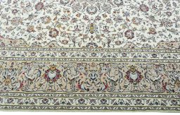 Corner detail of 2000s Kashan rug showing border pattern and Wool pile