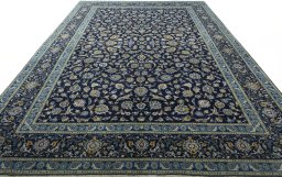 Corner detail of 2000s Kashan rug showing border pattern and Wool pile