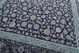 Backside of handmade 2000s Kashan rug showing knot structure and weave density