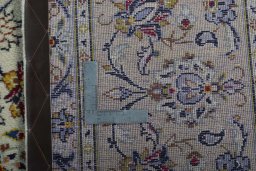 Backside of handmade 1970s Kashan rug showing knot structure and weave density